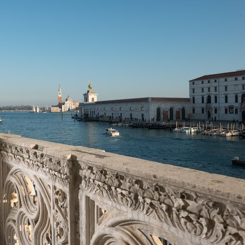 Take in the Grand Canal from the ornate stone balcony