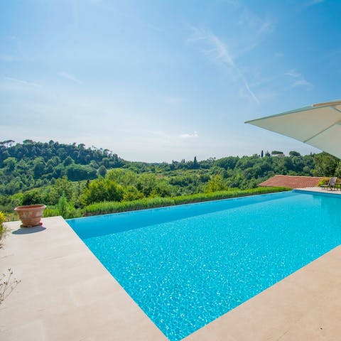 Admire views of the Tuscan hills from the poolside