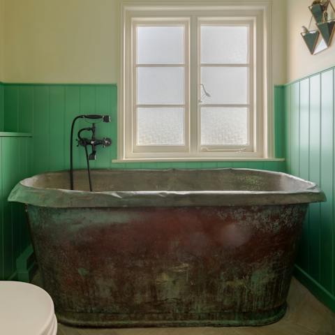 Relax after a long day with a soak in the roll-top bathtub