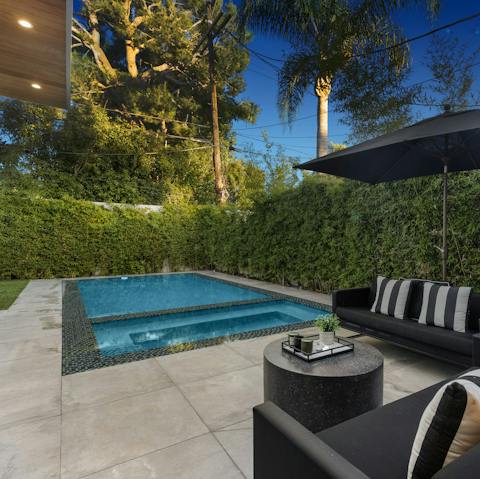 Hang out by the private pool and hot tub on a warm afternoon
