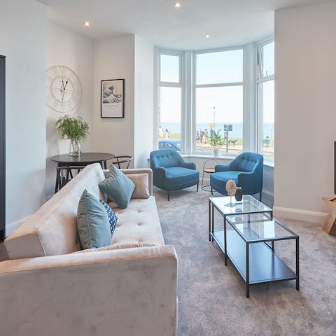 Relax in the bright living room while taking in gorgeous sea views from the bay window