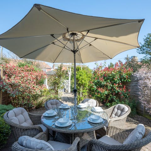 Delight in dining alfresco in the garden, surrounded by flowering plants and shrubs