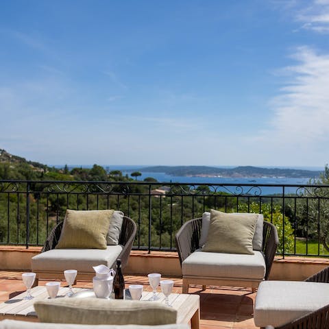 Relax with a glass of fizz on the terrace while admiring the sea views