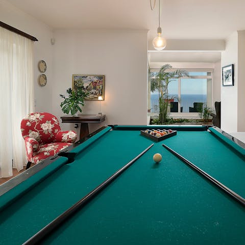 Get competitive around the billiards table after a day on the beach 