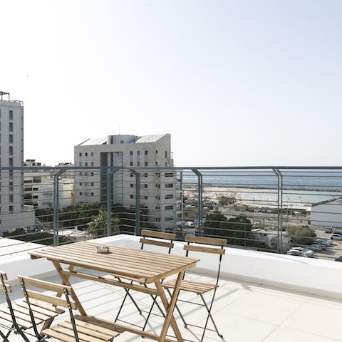 Enjoy dinner out on the roof terrace with a backdrop of the Mediterranean Sea