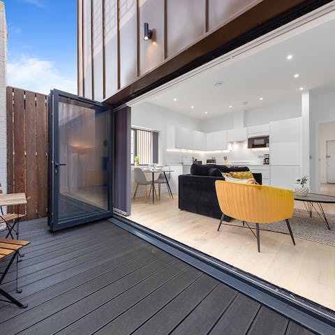Open up the glass patio doors, and blend the open-plan living with the outdoors
