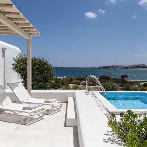 Take in the scenic views over the Aegean Sea from the sun loungers