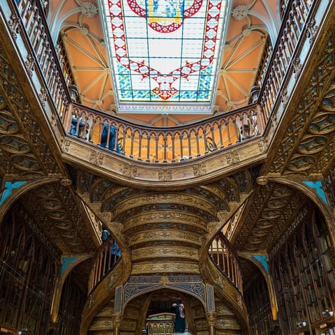 Visit Livraria Lello, one of the world's most beautiful bookstores, a twenty-five-minute stroll away