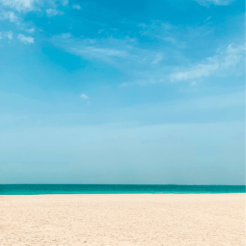 Sink your toes in the sand at Palm Jumeirah Beach, a one-minute walk away