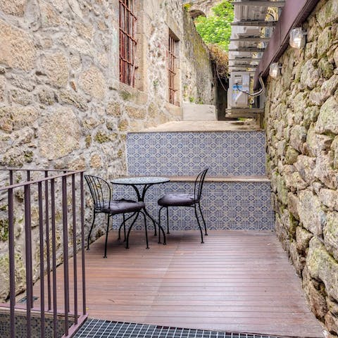 Relax with a drink on the private terrace with its traditional-style tiles
