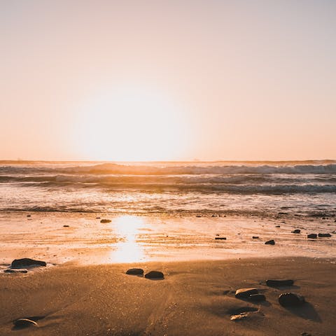 Stroll along Bakoven Beach at sunset, a six-minute walk away