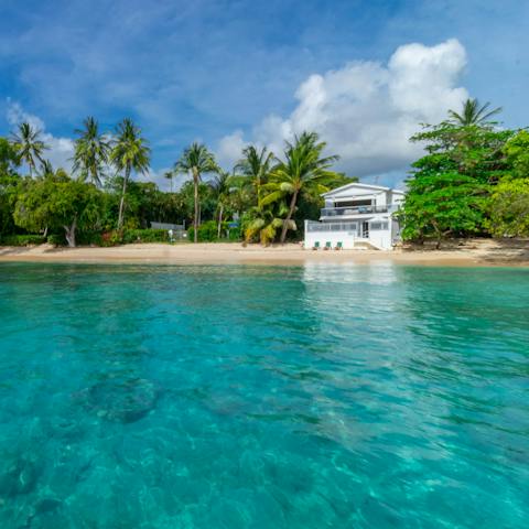 Stay just steps from the crystal-clear waters of the Caribbean