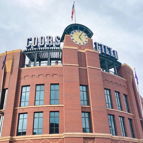 Watch a game of baseball at Coors Field,  a four-minute drive from your building