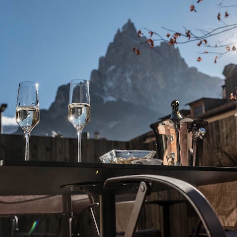 Sip celebratory champagne against a stunning mountain backdrop