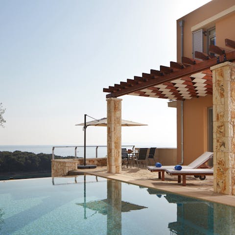 Take a refreshing dip in your private pool overlooking the ocean