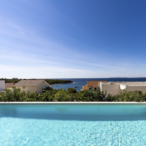 Spend blissful days lounging by the infinity pool, taking swims to the edge to take it the vista