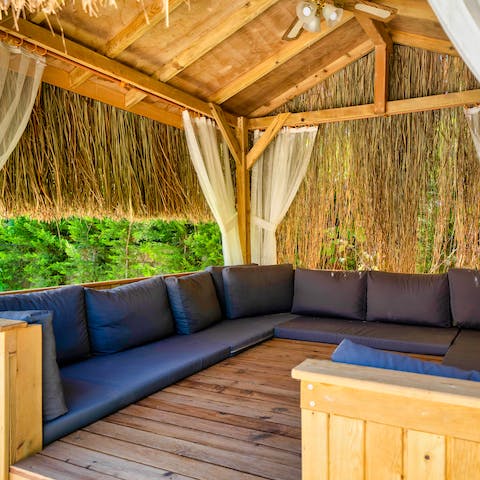 Enjoy the shade beneath the palm-frond cabana