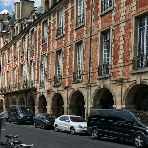 Visit the Place des Vosges, a walk or short ride away 