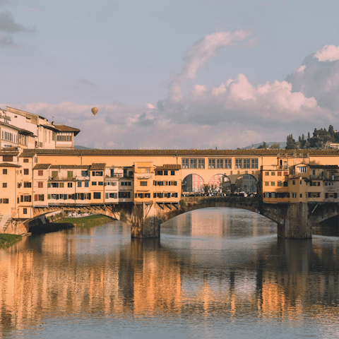 Admire the work of artisans while strolling across Ponte Vecchio