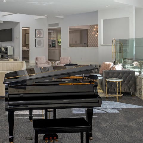 Show your musical side at the grand piano in the living area 