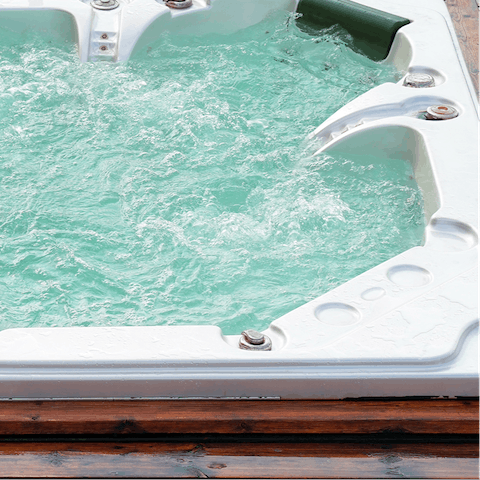 Enjoy a relaxing soak in your private outdoor hot tub 