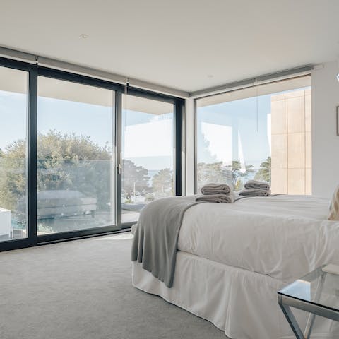 Awake to sea views beyond the trees in the master bedroom