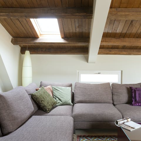 Snuggle up on the corner sofa under the sloped roof
