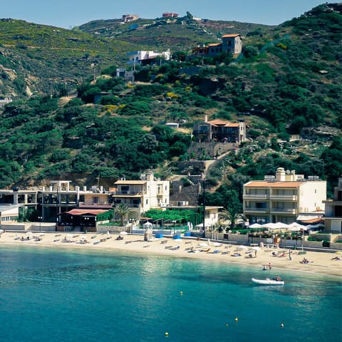 Drive down the hill to the sandy beach of Agia Pelagia