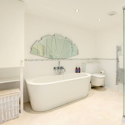 Treat yourself to a long soak in the master bathroom's freestanding tub after a day of Cheltenham sightseeing