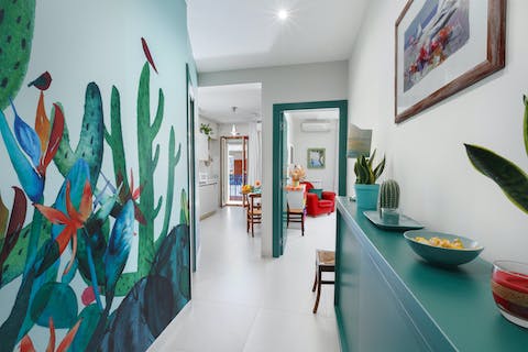 Relax amongst the home's fun and colourful interiors, with artistic murals and decor