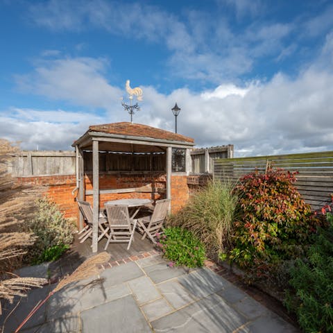 Head to the gazebo in the garden for a shaded drink or two