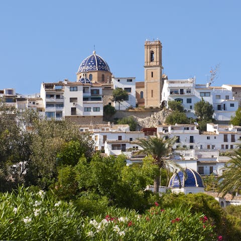 Stay in old town Altea, known as the Santorini of Spain as it cascades down to pebble beaches