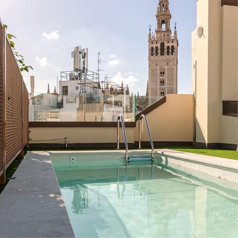 Gaze up at the Giralda as you bob about in the communal pool