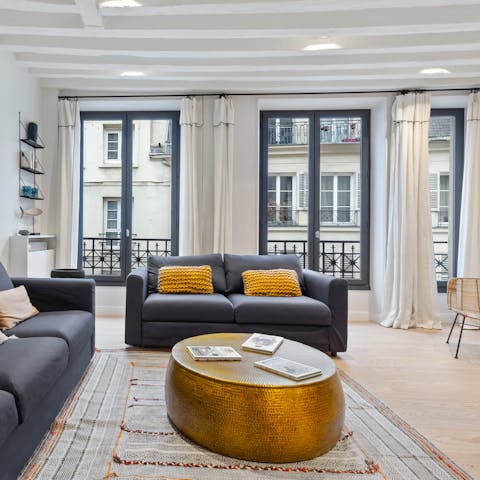 Kick back on the comfortable sofas or people watch from the living room's Juliet balconies with a glass of wine