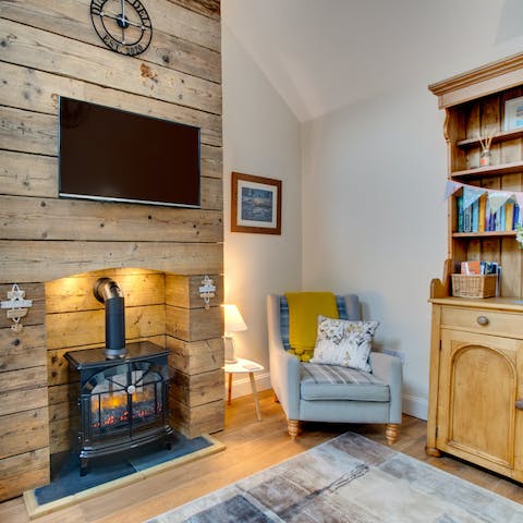 Cosy up by the electric wood burner with a good book