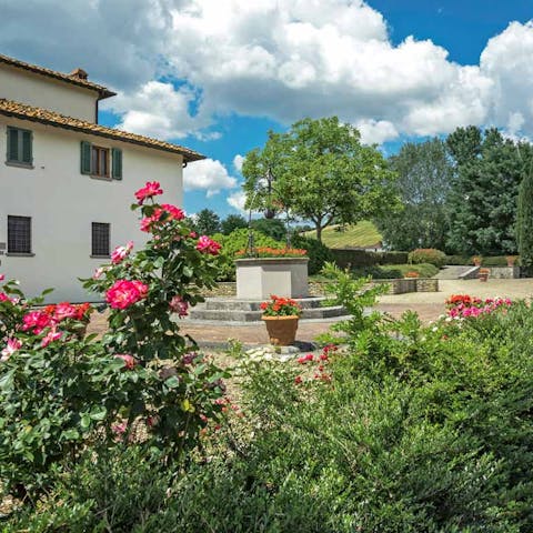 The garden features including a rose garden and a stone fountain