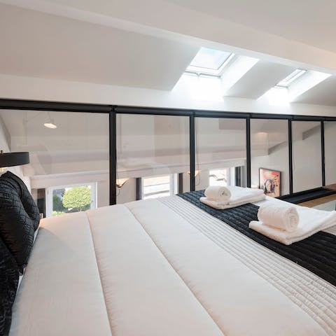 Gaze out over the living room from your mezzanine-level bed