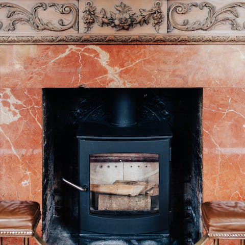 Sitting by the wood-burning stove you can admire the grand fireplace
