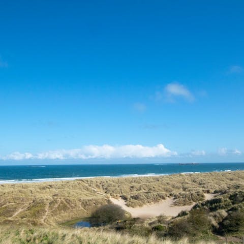 Walk to the long sandy beach that runs alongside Bamburgh