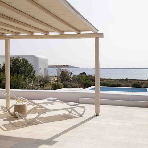 Let the hours pass you by while lazing poolside with sparking sea views