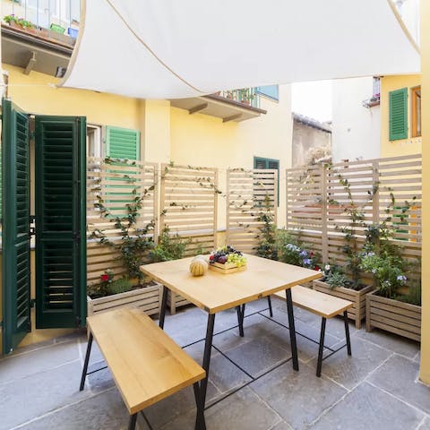 Enjoy a meal of authentic Italian pizza in the home's courtyard