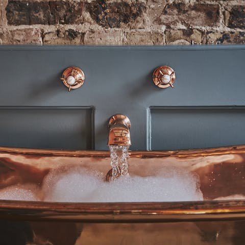 Treat yourself to a long and luxurious soak in the copper bathtub