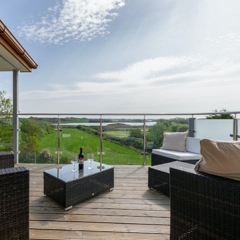 Admire the verdant view from your balcony with a bottle of red