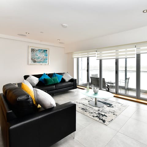 Open the bi-fold doors to the balcony and feel the sea breeze as you sprawl out on the leather sofas