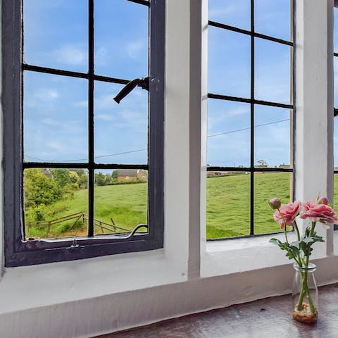 Look out to bucolic views of the Cotswolds countryside from the original lead pane windows