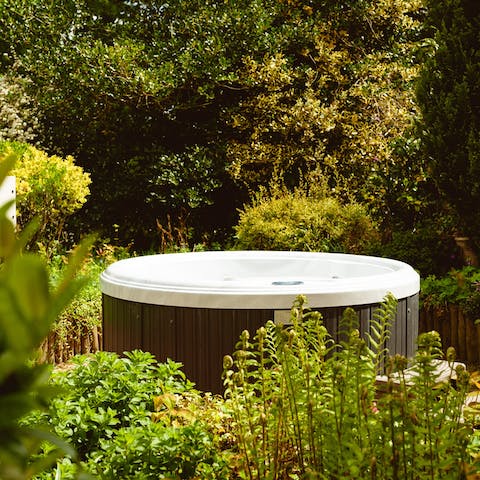 Indulge in a soak session in the garden hot tub at sunset