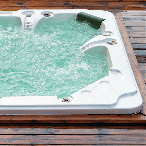 Enjoy a glass of fizz from the bubbling hot tub