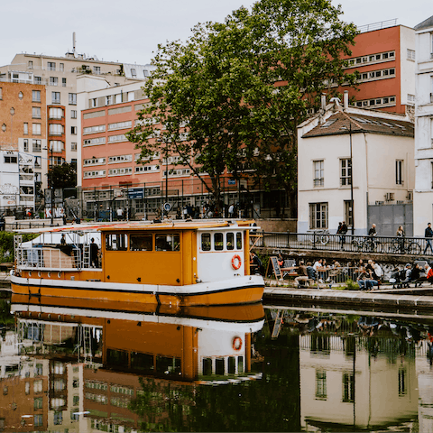 Spend a sunny afternoon drinking by the waterside at the Canal Saint-Martin, eleven minutes away