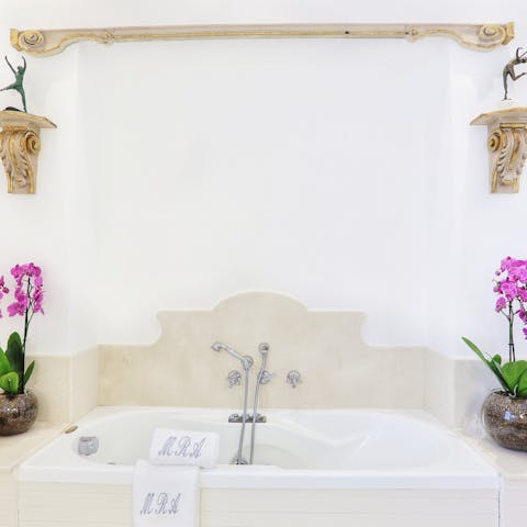 Sink into a relaxing bath surrounded by flowers and beautiful decor