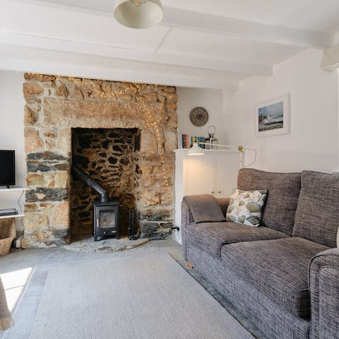 Sink into the plush sofa after a day of exploring Porthleven while the gas burning fireplace warms you up